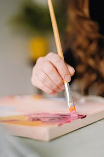 Palette with colourful paints and brushes